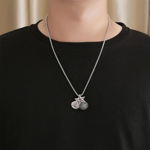 Vintage starfish and seashell pendant necklace in silver with red detail on a box chain