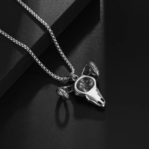 Retro stainless steel sheep skull pendant necklace with ox horns on a dark textured background