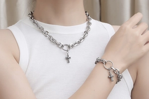 Close-up of men's stainless steel curb chain set with cross pendants on male model