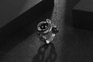 Macro shot of twin snake ring in vintage steel finish with a polished black stone