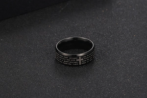 Close-up of matte black stainless steel ring with cross and Bible verse engraving