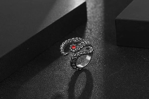 Detailed macro shot of vintage octopus tentacle ring with red gemstone eye