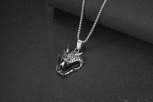 Detailed view of silver titanium steel dragon head pendant with realistic scale textures