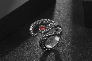 Macro shot of octopus tentacles stainless steel ring with a red gemstone detail