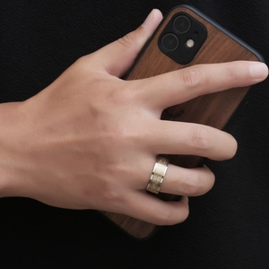 Two-tone silver and gold ring with Celtic knot pattern shown on male model hand