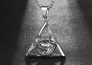 Close-up of a retro triangular All-Seeing Eye pendant with intricate hand carvings