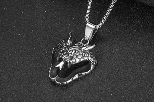 Macro side view of silver stainless steel cobra snake pendant with detailed scales