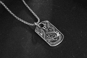 Macro detail of silver titanium steel dragon pendant with intricate vintage relief textures