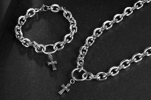 Detailed view of silver stainless steel cross pendant set with necklace and bracelet