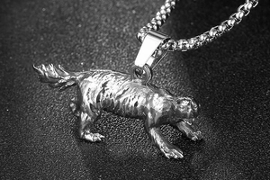 Macro shot of realistic stainless steel dog pendant with detailed fur texture on pearl chain