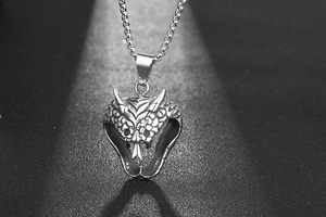 Detailed view of titanium steel cobra pendant with intricate snake scales and gothic texture