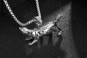 Detailed close-up of a vintage silver leopard pendant made of textured stainless steel