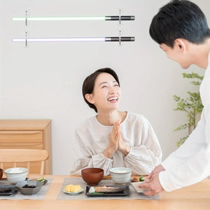 Wall mounted transparent racks holding green and purple glowing sabers in a home setting