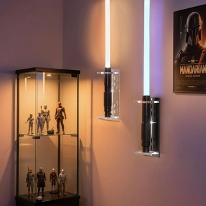 Vertical wall-mounted acrylic stand for lightsabers shown in a cinematic gaming room