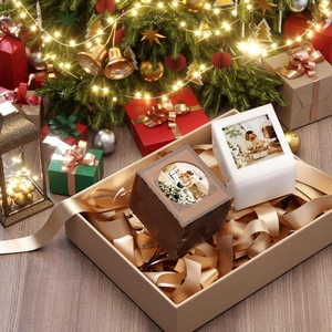 Close-up of customized amber acrylic photo display cube in festive Christmas gift setting