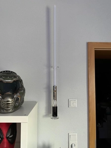 Detail of transparent acrylic wall mount rack showcasing lightsaber stand functionality