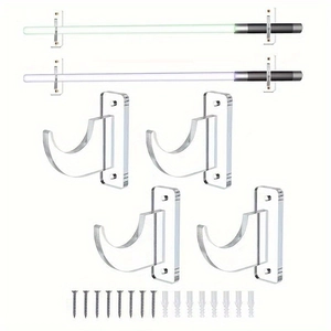 Macro view of four clear acrylic wall mount brackets with mounting screws and wall anchors