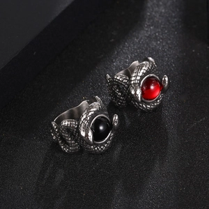 Retro titanium steel double snake rings with red and black gems on a black background
