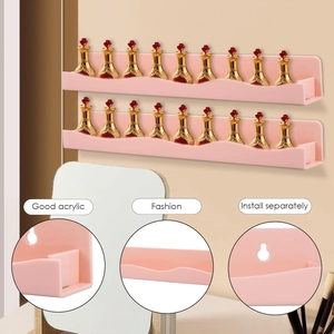 Detail of pink wavy acrylic floating shelves showing the wall-mount holes and thickness