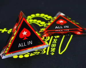 Macro detail of acrylic poker All In chips with red spade and white star design