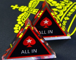 Close-up of double-sided acrylic All In poker dealer chips with red heart on black felt