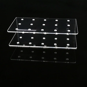 Three-tier transparent acrylic lollipop display stand with 15 holes on a black background