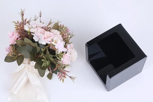 Detail view of the black acrylic tissue box with a U-shaped slot for easy paper access