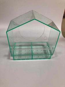 Macro detail of clear acrylic hanging bird feeder with dual compartments and roof design