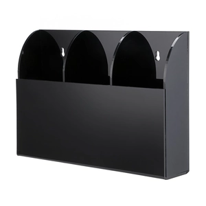 Macro detail of black acrylic wall mount storage organizer with three separate compartments