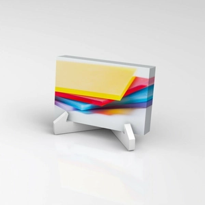 Vertical clear acrylic business card holder with colorful abstract pattern and white stand