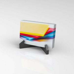 Modern acrylic business card holder with colorful geometric art and black cross display stand