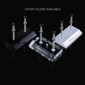 Close-up of wall-mounted acrylic skateboard racks in clear, black, and white finishes
