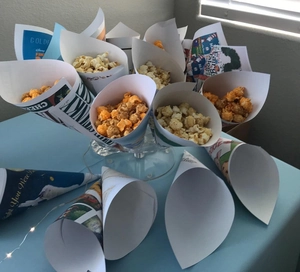 Close-up of printed paper cones with Disney and Peter Rabbit themes on a clear holder
