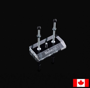 Close-up of clear acrylic skateboard wall mount with metal bolts on black background