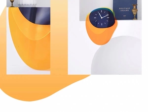 Detail view of modern layered acrylic wall clock with navy blue dial and orange accents
