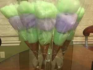 Detail view of 16-hole clear acrylic stand holding colorful marshmallow waffle cones