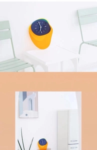 Detailed macro view of the yellow and blue acrylic wall clock with minimalist white hands