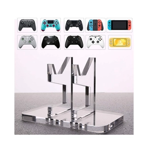 Clear acrylic double-tier stand showing compatibility with various game controllers