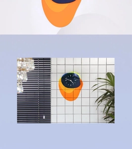 Macro detail of Nordic acrylic wall clock with colorful layered geometric shapes on tiles