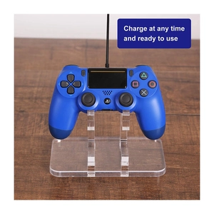 Transparent acrylic controller stand with L-shape design supporting a DualShock game controller