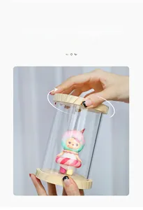 Detail of transparent display case with wooden lid showing secure twist-lock groove design