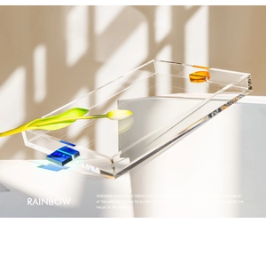 Detail of modern acrylic tray showing rainbow light effects and blue orange accents