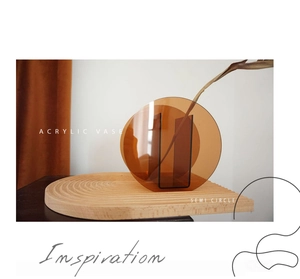 Macro detail of amber semi-circle acrylic vase with minimalist geometric design