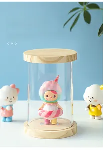 Clear acrylic cylinder display case with natural wood base for collectible action figures