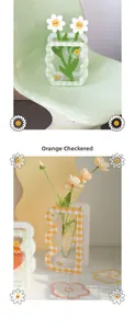 Detail of wavy acrylic vases with orange and green gingham patterns and daisies