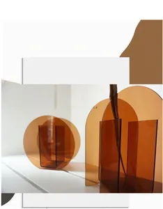 Artistic layout of amber geometric acrylic vases in semi-circle and arched shapes