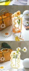 Close-up of a yellow gingham acrylic daisy flower vase in a cozy home decor setting