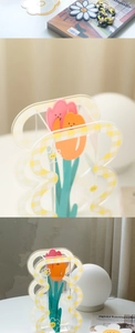 Detail of checkered acrylic tulip vase with smiley face inserts for home decor