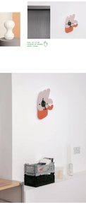 Detail of creative hand-shaped acrylic clock in pink and orange with 39x25cm dimensions
