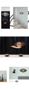 Modern eye-shaped acrylic wall clock with 50x25cm dimensions in artistic multi-color design
